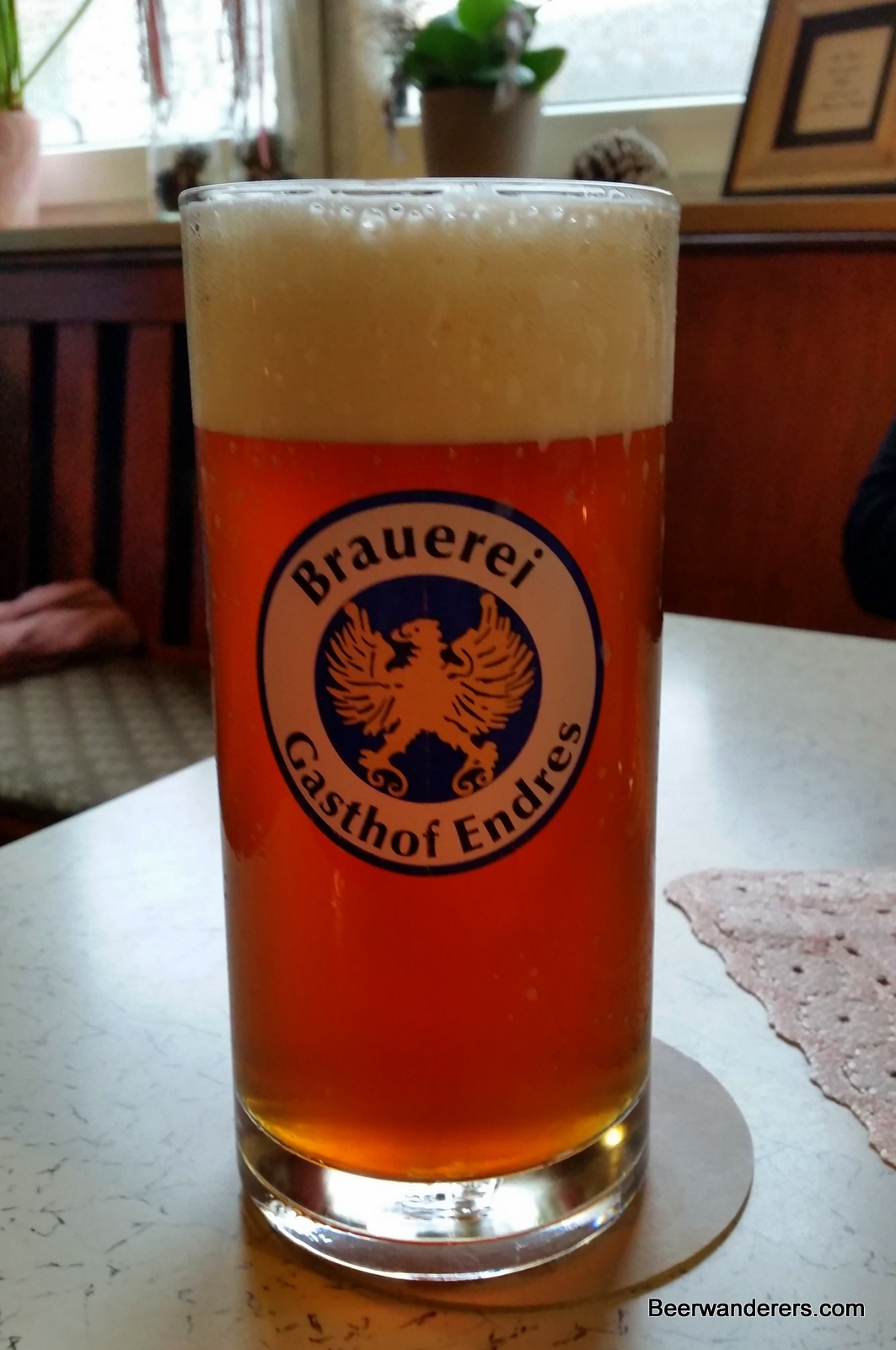 unfiltered beer in glass with big head
