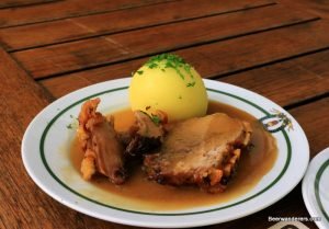 crispy roast port with dumpling in sauce