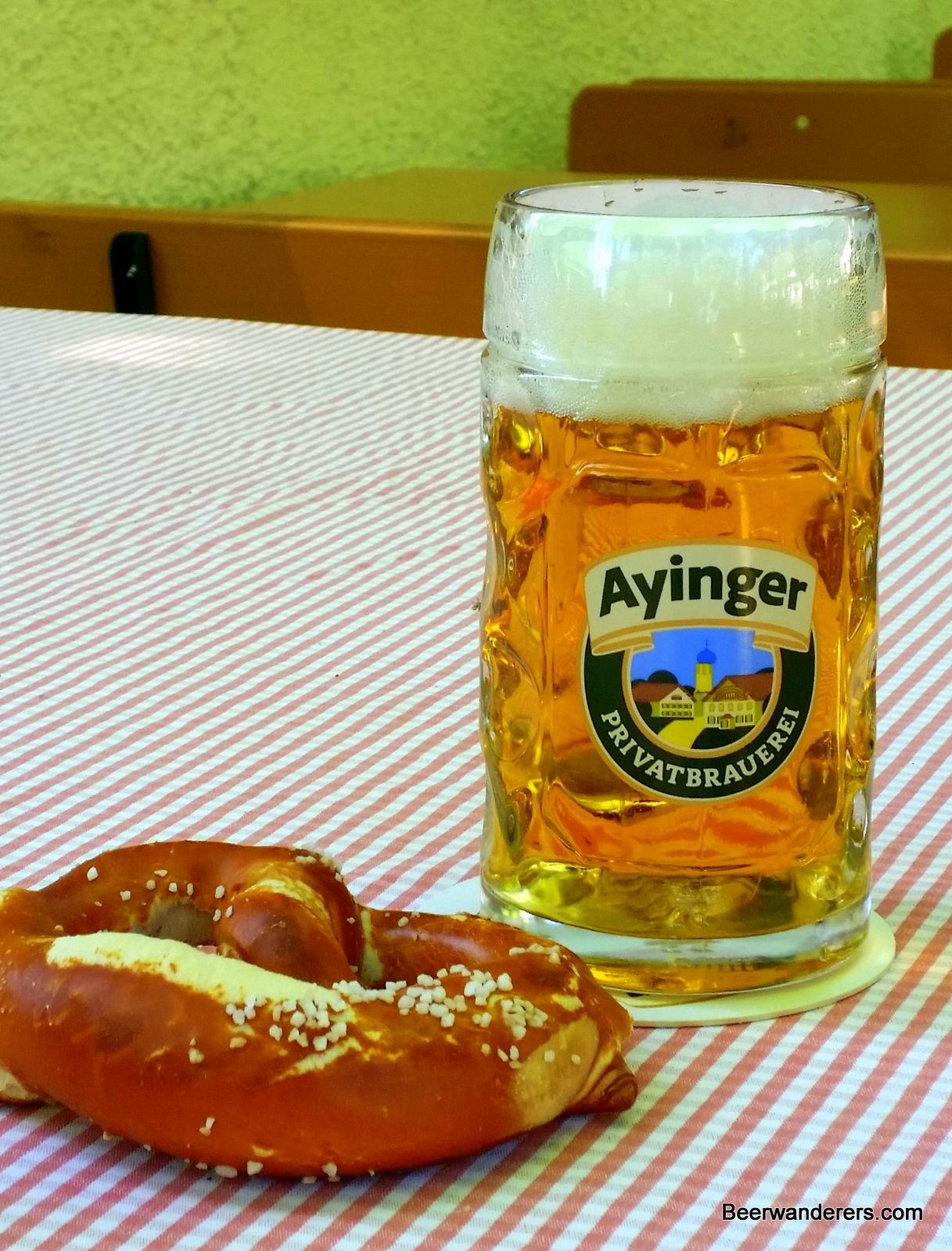 golden beer in mug with pretzel