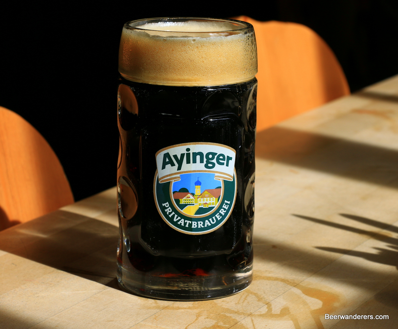 dark beer in mug with big tan head