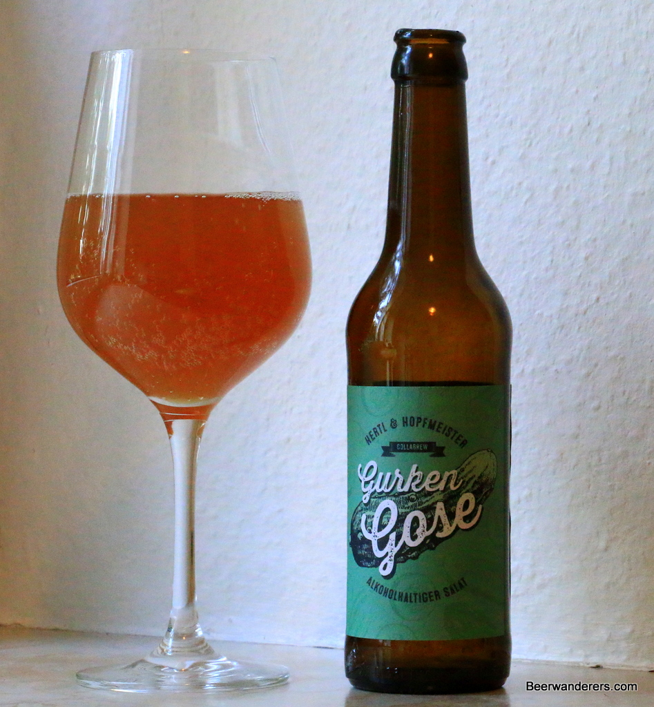 amber beer in wine glass with bottle