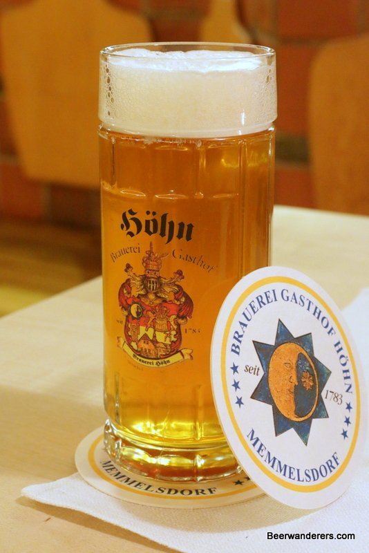 golden beer in mug with coaster