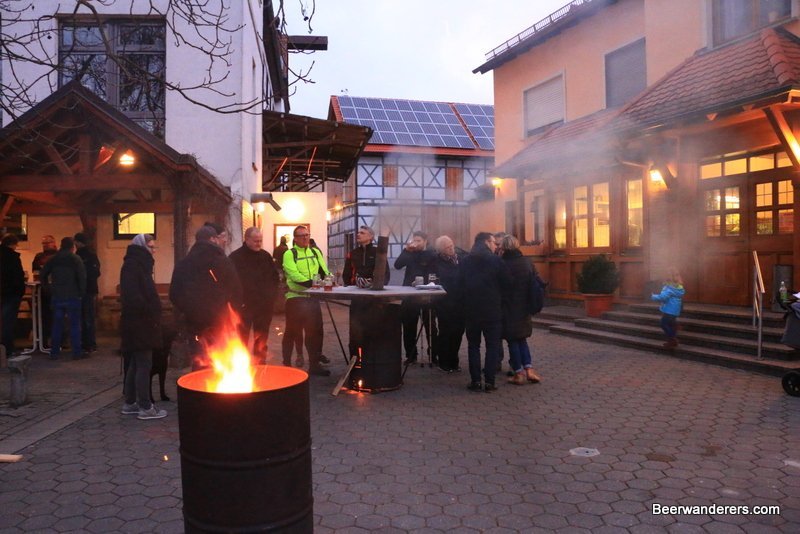 people outside in winter with a fire