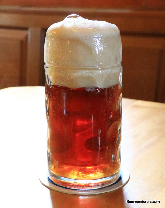 amber beer in mug with big head