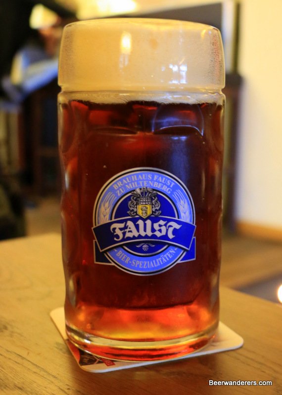 amber beer in mug with big head