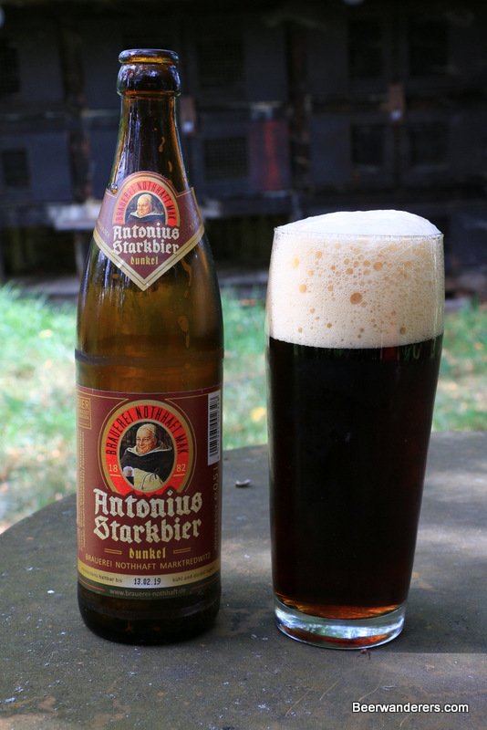dark beer in glass with bottle
