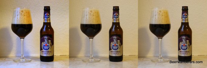 dark beer in wineglass with bottle x three