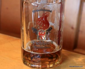 nearly empty beer mug with logo