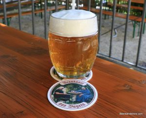 golden beer with big head in mug with beer coaster featuring nuns
