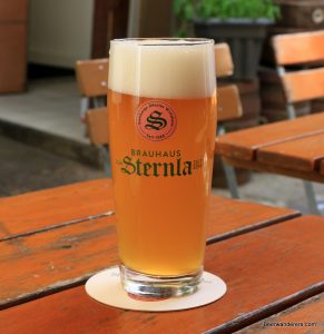 unfiltered golden beer in logo glass