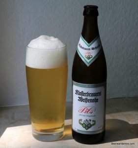 golden beer in glass with bottle