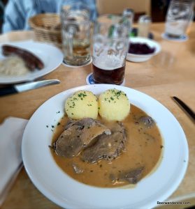 roast beef in sauce with dumplings and beer