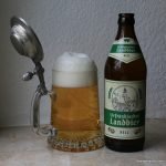 golden beer with big head in pewter lidded mug with bottle