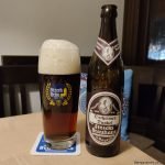 dark beer in logo glass with bottle