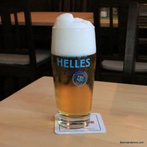 goldne beer with huge head in logo glass