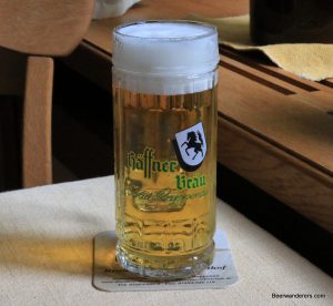 lightly filtered golden beer in logo mug
