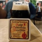 black beer in brandy snifter with coaster