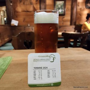 unfiltered amber beer with coaster