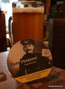 unfiltered amber beer in mug with coaster