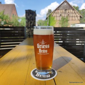 unfiltered amber beer in logo glass