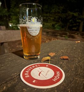 unfiltered golden beer in logo glass